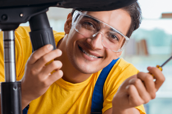 This is a picture of a man fixing an office chair.