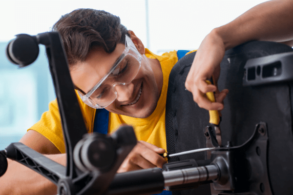 This is a picture of a man fixing an office chair.